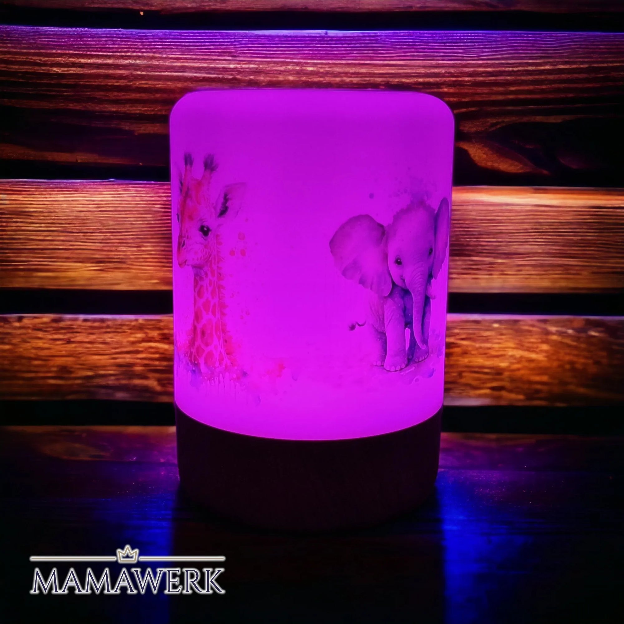 Violett erleuchtetes LED-Nachtlicht mit Holzsockel und Giraffen- und Elefant-Motiv, mit Namen personalisiert. Vor holzigem Hintergrund stehend.
